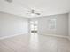 Spacious living room featuring tile floors and a ceiling fan at 9835 Lemon Drop Loop, Sun City Center, FL 33573