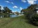 Peaceful backyard view of a canal with lush greenery at 2119 Cattleman Dr, Brandon, FL 33511