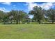 Park with grassy areas, benches, and trees at 311 80Th Ne Ave, St Petersburg, FL 33702