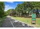 Paved walking trail winds through lush landscaping at 311 80Th Ne Ave, St Petersburg, FL 33702
