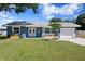 Newly renovated light blue house with a two-car garage and landscaped yard at 311 80Th Ne Ave, St Petersburg, FL 33702
