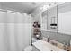 Clean bathroom with a white vanity, shower/tub combo and mirrored medicine cabinet at 3334 W Heiter St, Tampa, FL 33607