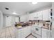 Efficient kitchen with white cabinets, built-in microwave, and electric range at 3334 W Heiter St, Tampa, FL 33607