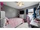 Bedroom with pink bedding, desk and gaming chair at 3334 W Heiter St, Tampa, FL 33607