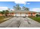 Front view of a duplex featuring a two-car garage for each unit at 3334 W Heiter St, Tampa, FL 33607