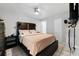 Main bedroom with a dark brown platform bed and ceiling fan at 3334 W Heiter St, Tampa, FL 33607