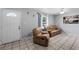 Bright living room featuring tiled floors and comfy leather reclining furniture at 3334 W Heiter St, Tampa, FL 33607