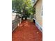 Landscaped side yard with red mulch and privacy fence at 37611 Gaddis St, Dade City, FL 33523