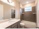 Bathroom with shower/tub combo and gray tile at 411 Seasons Dr, Punta Gorda, FL 33983