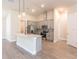 Modern kitchen with gray cabinets, quartz countertops, and stainless steel appliances at 411 Seasons Dr, Punta Gorda, FL 33983