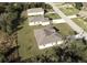 Aerial view showing two houses on a large lot with green space at 411 Seasons Dr, Punta Gorda, FL 33983