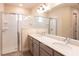Double vanity bathroom with a walk-in shower at 411 Seasons Dr, Punta Gorda, FL 33983