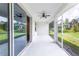Relaxing screened patio with ceiling fan and access to backyard at 411 Seasons Dr, Punta Gorda, FL 33983
