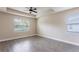 Well-lit bedroom featuring tile floors and neutral tones at 411 Seasons Dr, Punta Gorda, FL 33983