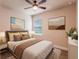 Bright bedroom with a ceiling fan, neutral tones, and modern decor at 411 Seasons Dr, Punta Gorda, FL 33983