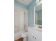 Updated bathroom features a white vanity, tub shower, and light blue walls at 6126 Beechwood Dr, Dade City, FL 33523