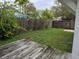 A view of the spacious backyard featuring a wooden deck and perimeter fence at 301 W Chelsea St, Tampa, FL 33603