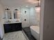 Stunning bathroom featuring a standalone tub, sleek vanity, and crystal chandelier at 301 W Chelsea St, Tampa, FL 33603