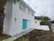 Charming two-story home featuring a striking teal-colored door and a well-maintained, newly painted exterior at 301 W Chelsea St, Tampa, FL 33603