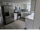 Updated kitchen with stainless steel appliances, white cabinetry, and modern backsplash at 301 W Chelsea St, Tampa, FL 33603
