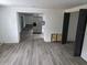 Open-concept floor plan with new flooring connecting the living area and kitchen at 301 W Chelsea St, Tampa, FL 33603