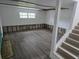 Renovated living room with new flooring and a window providing natural light at 301 W Chelsea St, Tampa, FL 33603