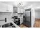 Updated kitchen with stainless steel appliances and white cabinets at 3330 W Heiter St, Tampa, FL 33607