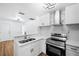 Renovated kitchen, showcasing new cabinetry and stainless steel appliances at 3330 W Heiter St, Tampa, FL 33607