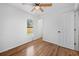 Bright bedroom with wood-look floors, a ceiling fan, and access to a shared bath at 3330 W Heiter St, Tampa, FL 33607