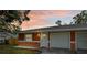 Orange house with attached two car garage at 3330 W Heiter St, Tampa, FL 33607