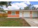 Orange duplex with attached garages at 3330 W Heiter St, Tampa, FL 33607