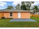 Newly constructed home with a fenced backyard, patio, and grassy area at 3330 W Heiter St, Tampa, FL 33607