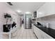 Modern kitchen with white cabinets, black countertops and appliances at 3336 W Heiter St, Tampa, FL 33607