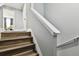 Modern staircase with wood flooring and white railing at 4516 Bay Spring Ct, Tampa, FL 33611