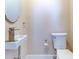 Small bathroom with updated sink and toilet at 518 Riverside Dr, Tarpon Springs, FL 34689