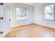 Spacious bedroom with hardwood floors and large windows at 518 Riverside Dr, Tarpon Springs, FL 34689