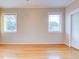 Bright bedroom with hardwood floors and two windows at 518 Riverside Dr, Tarpon Springs, FL 34689