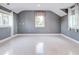 Bright bedroom with grey walls, white flooring, and two windows at 518 Riverside Dr, Tarpon Springs, FL 34689