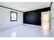 Bedroom with white walls, dark accent wall, and white flooring at 518 Riverside Dr, Tarpon Springs, FL 34689