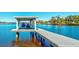 Covered boat lift and dock on calm water at 518 Riverside Dr, Tarpon Springs, FL 34689
