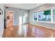 Bright breakfast room with hardwood floors, view of backyard and kitchen access at 518 Riverside Dr, Tarpon Springs, FL 34689