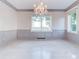 Bright dining room with water views, chandelier, and elegant wall paneling at 518 Riverside Dr, Tarpon Springs, FL 34689