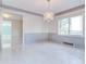 Elegant dining room with hardwood floors, a chandelier, and wainscoting at 518 Riverside Dr, Tarpon Springs, FL 34689