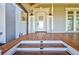 Front porch with wooden steps and a white door with glass panels at 518 Riverside Dr, Tarpon Springs, FL 34689