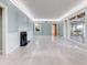 Spacious living room with fireplace, hardwood floors, and large windows at 518 Riverside Dr, Tarpon Springs, FL 34689
