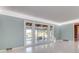 Living room with hardwood floors, light walls and large windows overlooking the water at 518 Riverside Dr, Tarpon Springs, FL 34689