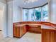 Built-in office space with wood cabinets and a large window at 518 Riverside Dr, Tarpon Springs, FL 34689