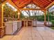 Outdoor kitchen with stone countertops, a sink, and a built-in refrigerator at 518 Riverside Dr, Tarpon Springs, FL 34689