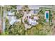 Aerial view of an estate with a large home, guest house, pool, and meticulously landscaped grounds at 518 Riverside Dr, Tarpon Springs, FL 34689