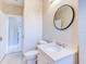 Bright bathroom featuring a modern round mirror, sleek vanity, and stylish fixtures at 518 Riverside Dr, Tarpon Springs, FL 34689